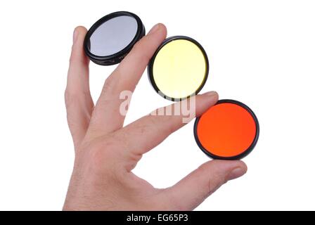 man hand holds three photographic filters, isolated on white background Stock Photo