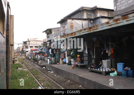 People living along the railway. Maninal train Station. Slum dwellings in Blumentritt Manila. Rail track and squatters at Blumentritt Manila. Stock Photo