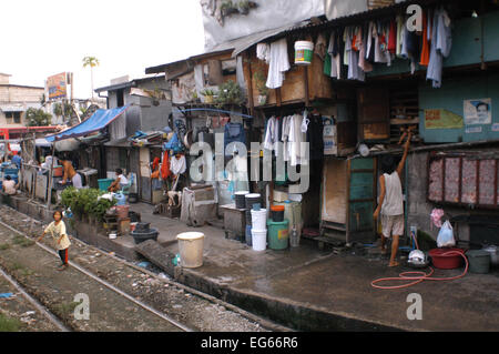 People living along the railway. Maninal train Station. Slum dwellings in Blumentritt Manila. Rail track and squatters at Blumentritt Manila. Stock Photo