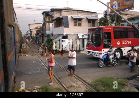 New coach bus. People living along the railway. Maninal train Station. Slum dwellings in Blumentritt Manila. Rail track and squatters at Blumentritt Manila. Stock Photo