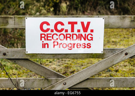 Sign on a wooden gate advising public that CCTV recording is in progress Stock Photo