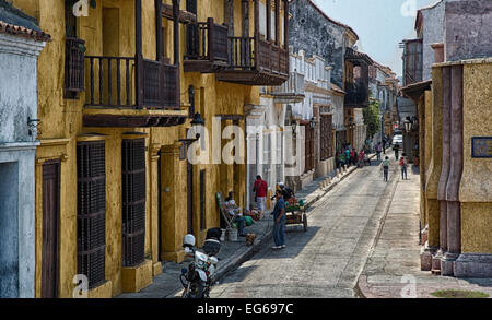 Cartagena, Colombia - February 22, 2014 - Tourists and locals walk through the picture perfect streets of Cartagena. Stock Photo