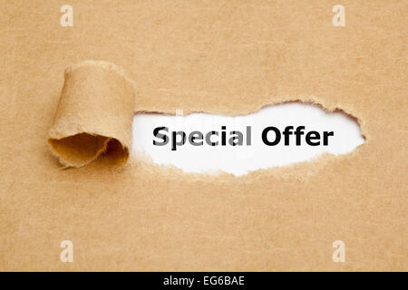 Special Offer appearing behind torn brown paper. Stock Photo