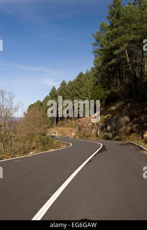 Mountain road with many curves, in blue sky background Stock Photo