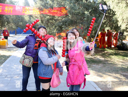 Beijing, China. 18th Feb, 2015. Visitors take a selfie at the annual temple fair at Ditan Park, also known as the Temple of Earth, Feb. 18, 2015. The eight-day temple fair kicked off here on Wednesday, on the eve of the Lunar New Year. Credit:  Xinhua/Alamy Live News Stock Photo