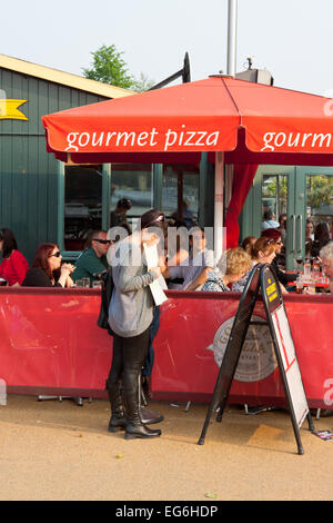 Woman reading menu at Gourmet Pizza restaurant on the South Bank near Gabriel's Wharf Stock Photo