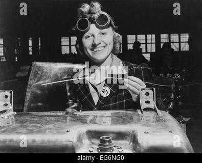 Woman welding a fuel tank for a Hawker Hurricane fighter airplane at Fort William, Ontario, Canada. 1941. World War 2. Stock Photo