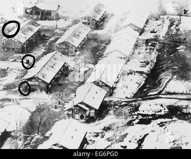 Aerial photo taken by a low flying U.S. Air Force jet of Chiktong POW camp in North Korea. In the circles are men, some waving. Stock Photo