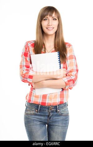 Young standing girl with notebook isolated on white background Stock Photo