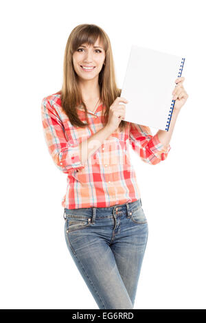 Pretty young woman showing empty sheet of notepad isolated on white background. Caucasian student girl with copy space on notebo Stock Photo