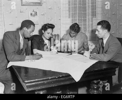 Polly Johnson (2nd from right) is assisted in signing an affidavit for the NAACP. It documented her involuntary servitude at Stock Photo