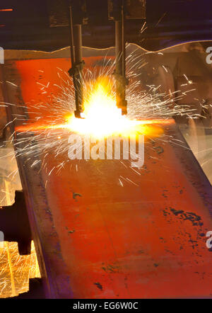 Gas cutting of the hot metal inside of plant Stock Photo