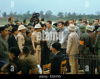 116 pilots and soldiers of the US army, who had been captured by the North Vietnamese People's Army during Vietnam War, were turned over to the United States of America in Hanoi on the 12th of February in 1973. US military in grey jackets walk to the planes at the Airport of Hanoi. The prisoners of war were brought to Clark Air Base on the Philippines within the 'Operation Homecoming'. The United States of America flew about 2,000 air attacks on cities and targets in North Vietnam during the 'Christmas bombings' in 1972. The peace agreement was signed on the 27th of January in 1973 in Paris. Stock Photo