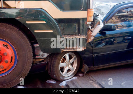 The aftermath of a head on collision between a car and a truck on National Road 7 in Kampong Cham, Cambodia. Stock Photo