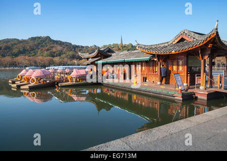 Hangzhou, China - December 5, 2014: Chinese recreation boats are moored on the West Lake coast. Famous park in Hangzhou city Stock Photo