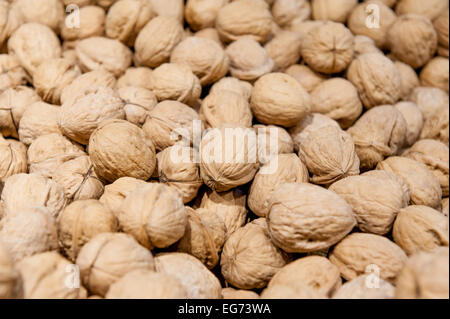 Detail of heap of walnuts in market, focus at center Stock Photo