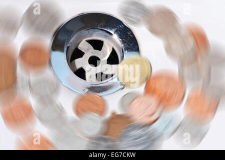 Wasted money going down the drain Stock Photo