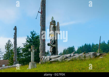 Totem poles in cemetary, Alert Bay, Cormorant Island,  British Columbia, Canada Stock Photo