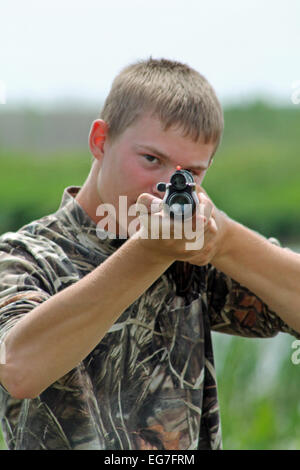Man with gun pointing while hunting Stock Photo