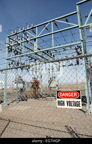 A High voltage warning sign on the fence around an electrical substation.