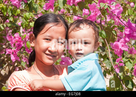 Young girl with small child on the arm, Phu Quoc, Vietnam, Asia Stock Photo