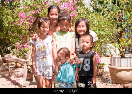 Young girl with small child on the arm, Phu Quoc, Vietnam, Asia Stock Photo