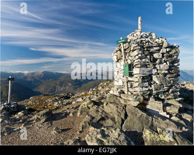 Top of mount Molden, stone cairn,  view towards north,  glacier Jostedalsbre in the background Stock Photo