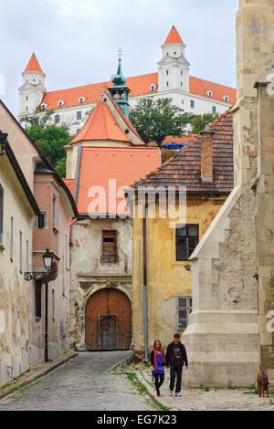 Old town street with castle in background, Bratislava, Slovakia Stock Photo