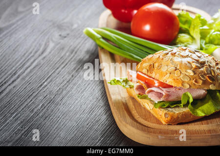 A fresh deli sandwich with ham, radish, tomatoes Stock Photo