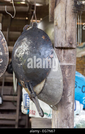 pans hanging on a wooden beam Stock Photo