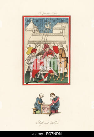 Board games of chess and tables (backgammon) from 14th century manuscripts. Knights in armour playing chess watched by other knights in front of a military encampment. Stock Photo