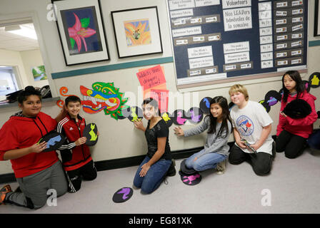 (150219) -- VANCOUVER, Canada, Feb. 19, 2015 (Xinhua) -- Pupils pose with a Chinese dragon decoration displayed on the wall at the Whiteside Elementary School in Richmond, Canada, Feb. 18, 2015. Schools in Vancouver area held different events with the theme of Chinese Lunar New Year for children to learn Chinese culture. (Xinhua/Liang Sen) Stock Photo