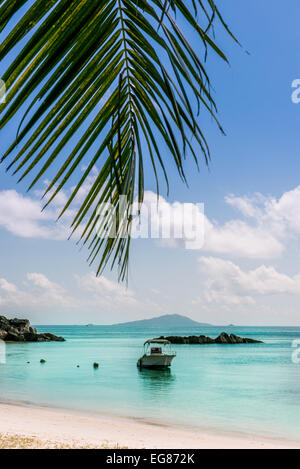 Boat on Tropical beach at Curieuse island Seychelles. Vertical shot Stock Photo