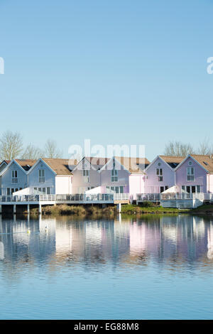 Clapperboard style houses along a lake at the watermark club, Cotswold Water Park, Gloucestershire, England Stock Photo