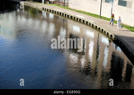 Two women walk by Regent's canal. Stock Photo