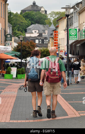 GEROLSTEIN, GERMANY - AUGUST 2010: Senior backpack tourists in Gerolstein, Germany Stock Photo