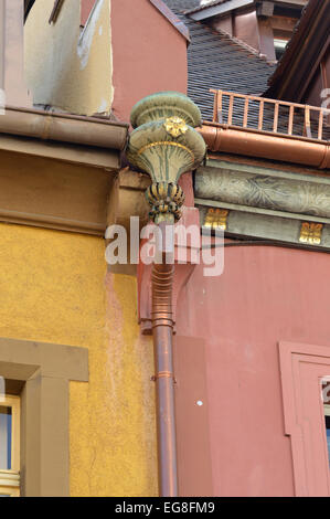 Copper rain gutter, A detail from a decorated rain gutter with drainpipe on a building in the historic old city of Freiburg Stock Photo