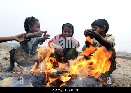 Homeless children create fire by using discarded wood or plastic to provide some warmth as winter temperatures d Stock Photo