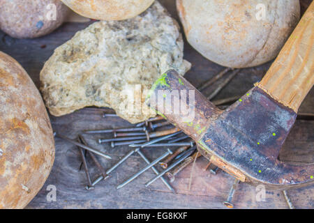 Hammer nails placed on the stone. Stock Photo