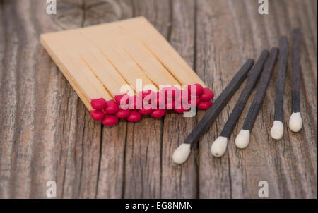 red and black matches on wood Stock Photo