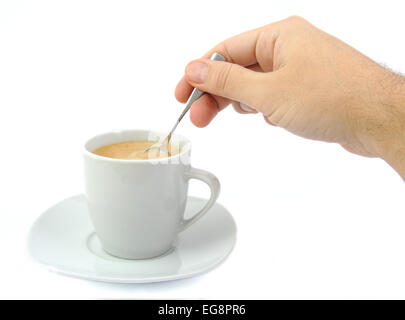 Hand stirring a cup of coffee on a bright background Stock Photo