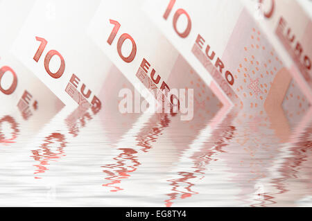 10 euro notes falling into a digitally created pool of water Stock Photo