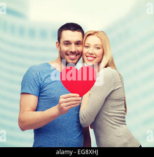 smiling couple holding big red heart Stock Photo