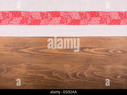 Old red and white patterned kitchen towel on dark wooden background Stock Photo