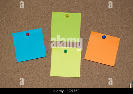 Multi Coloured sticky notes on a Cork Board Stock Photo