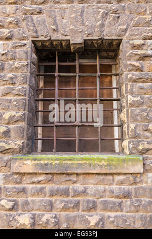 Rusty metal window grille in the stone wall of a building, Nottingham, England, UK Stock Photo