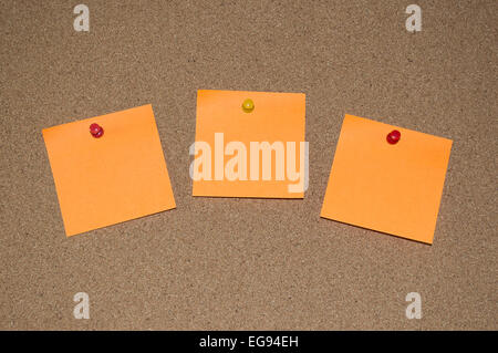 Orange sticky Notes on a Cork Board Stock Photo