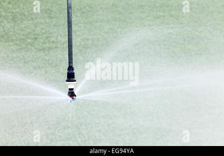 A closeup view of a high tech water conserving agricultural sprinkler head for irrigating farm crops. Stock Photo