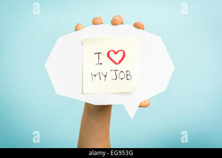 Yellow adhesive note on speech bubble with "I love my job" words Stock Photo