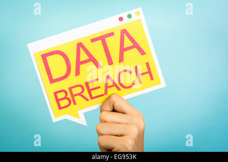Hand holding a speech bubble with "Data Breach" words. Security concept. Stock Photo